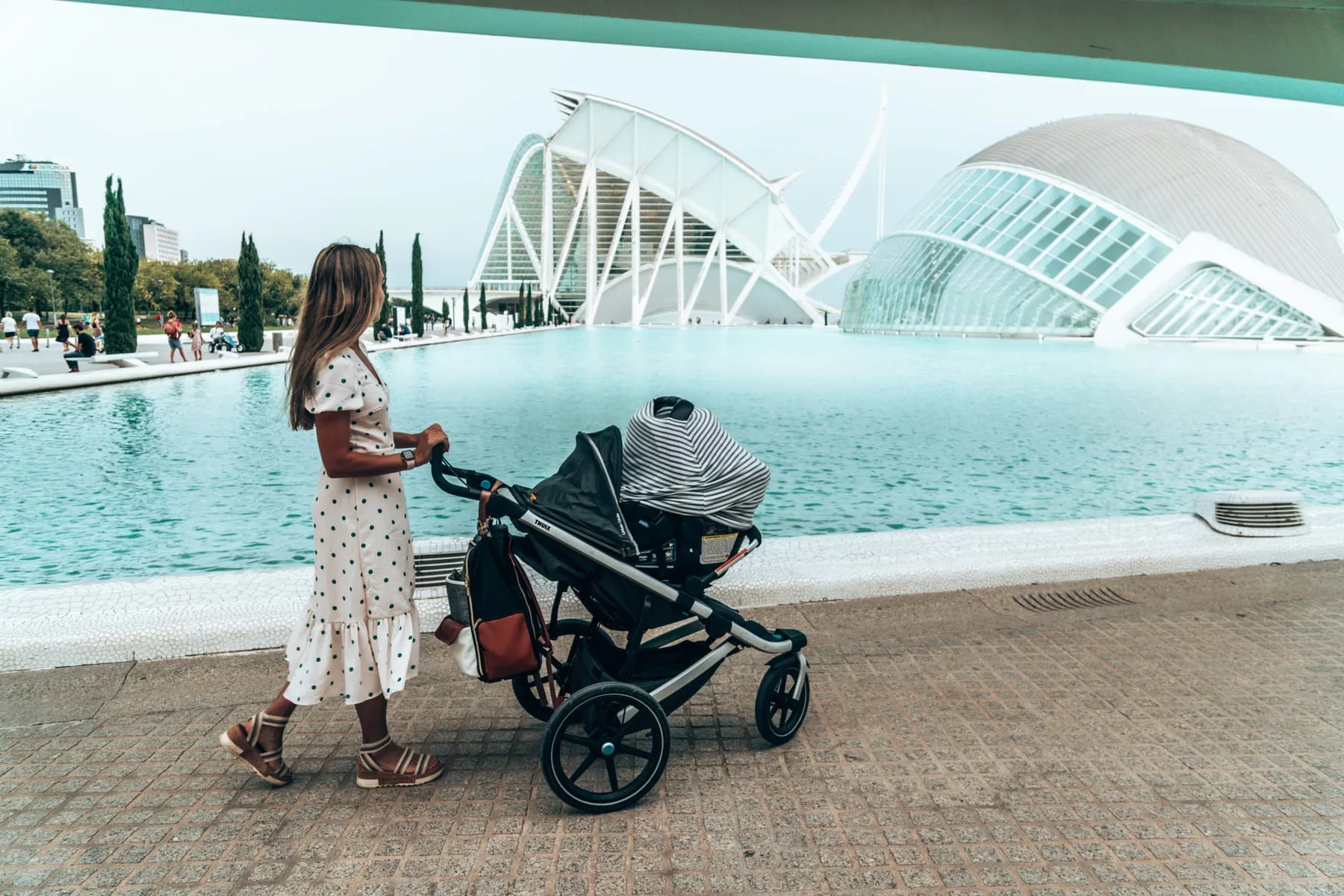 Kiersten pushing the travel stroller past the City of Arts and Sciences in Valencia