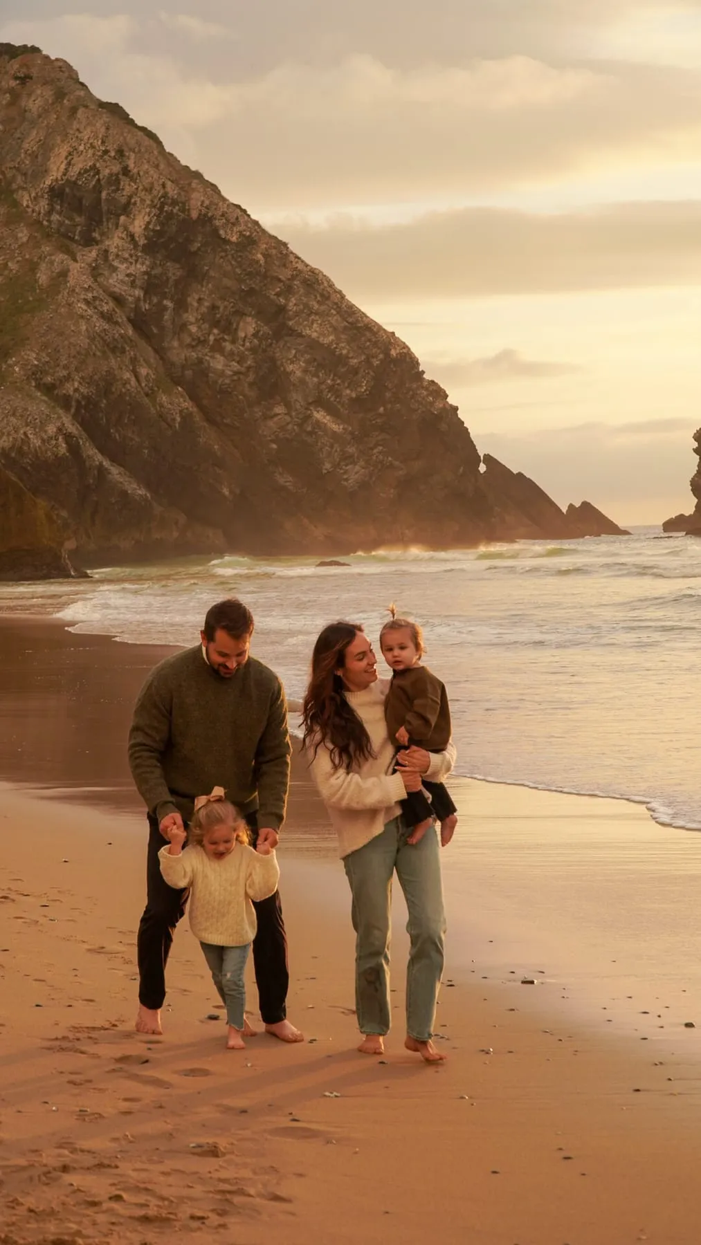 The four of us on the beach below the cliffs in Portugal at sunset