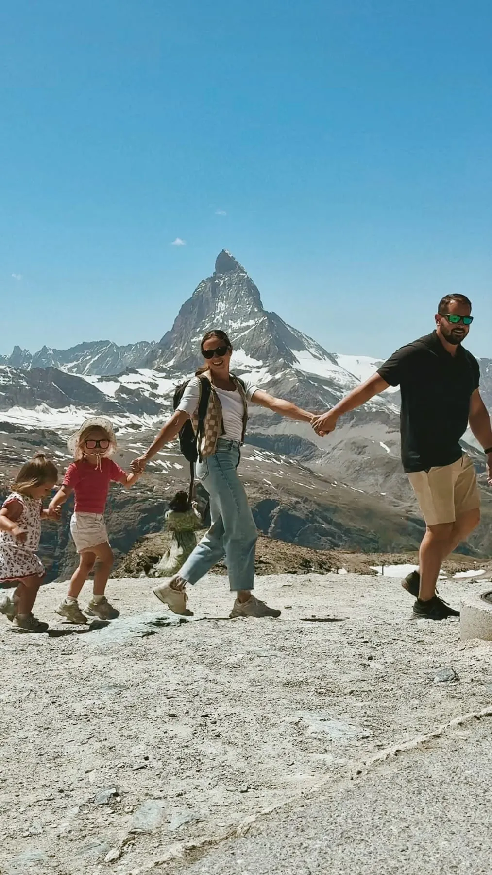 The four of us walking hand in hand toward the Matterhorn in Switzerland