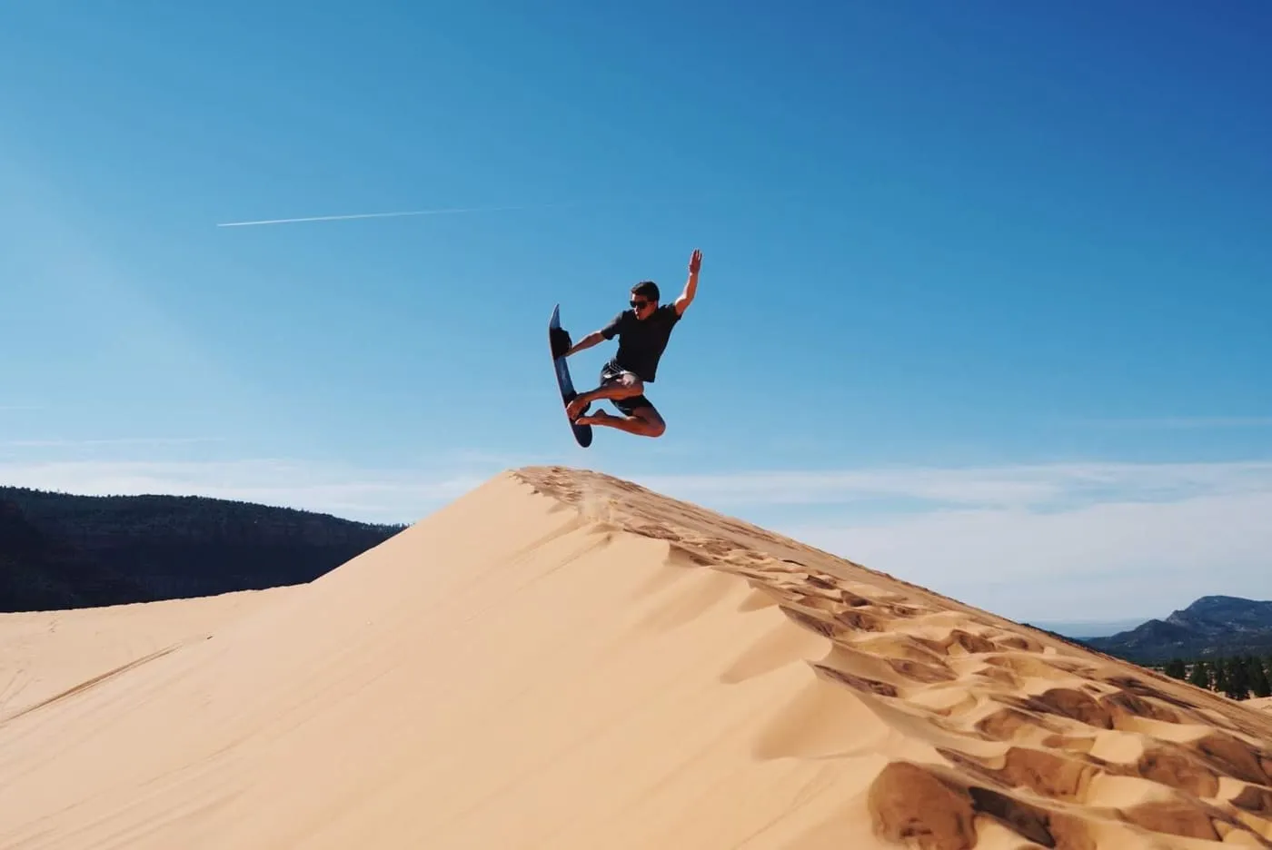 Jumping off a dune at Coral Pink Sand Dunes State Park